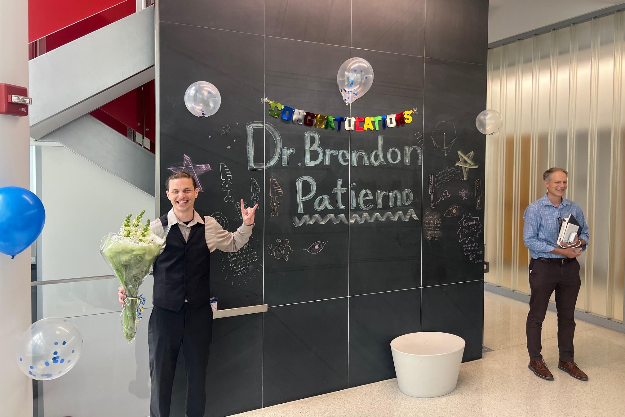 Brendon celebrating his thesis defense
